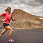 Anja Beranek monitoring her vital sign during excercise on a desert road