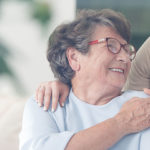 happy patient holding caregiver for a hand while spending time together