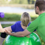 The trainer corrects the athlet's posture