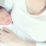 Mother holding feverish baby